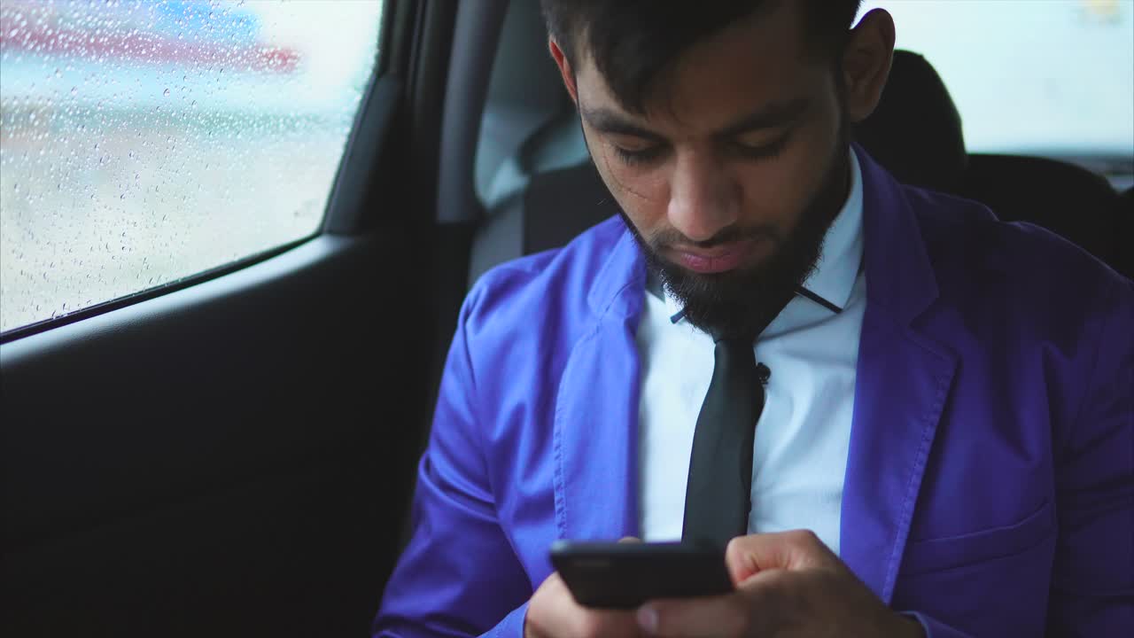Businessman Texting in Car During Rain
