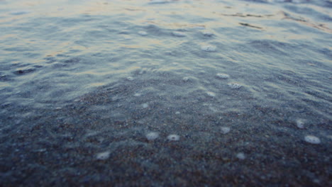 blue ocean water waves splashing sandy beach in slow motion. abstract nature