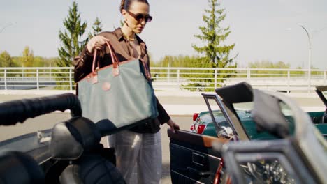 woman driving a vintage convertible car