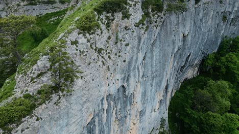 aerial dolly above sheer broken white grey cliff face in vietnam