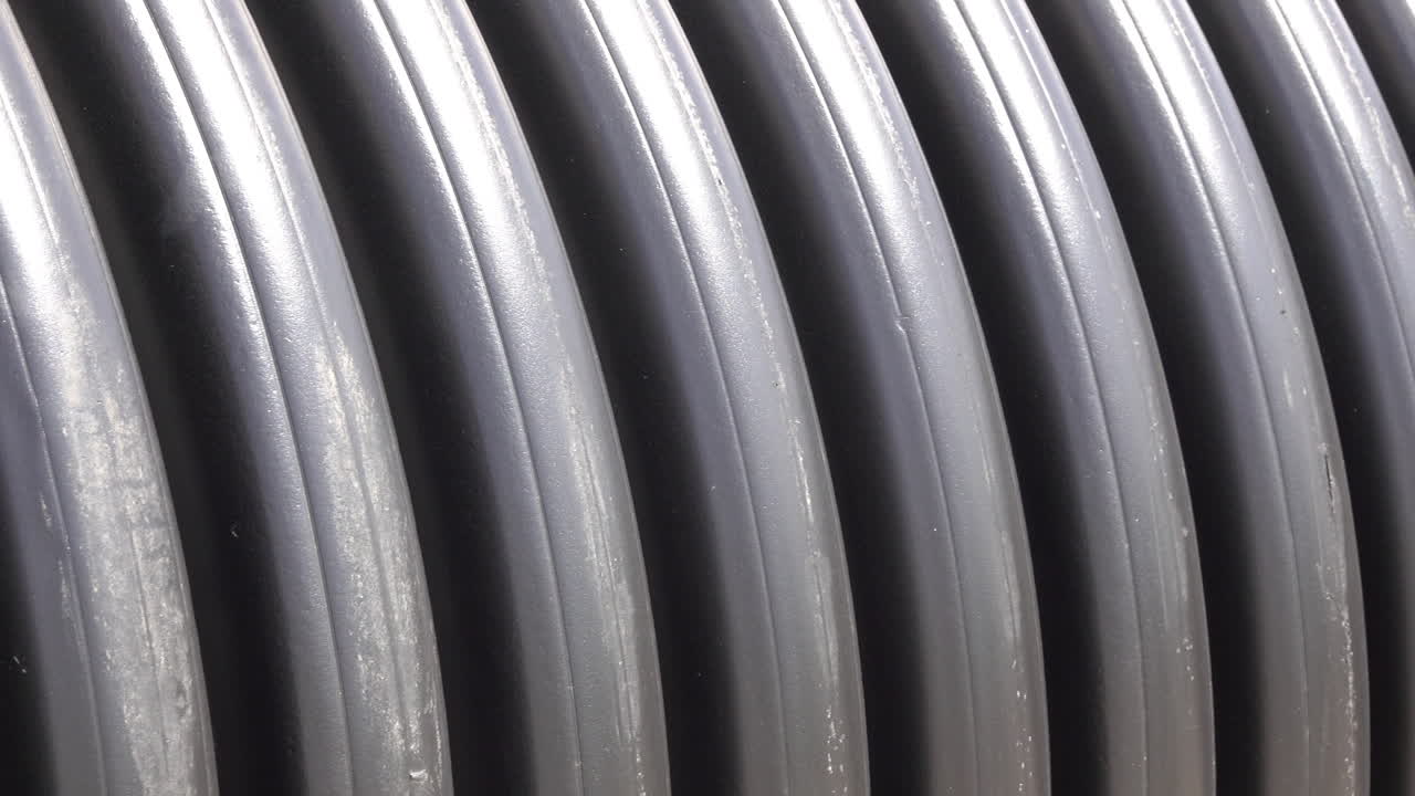 Pan to right across the rings of corrugated pipes