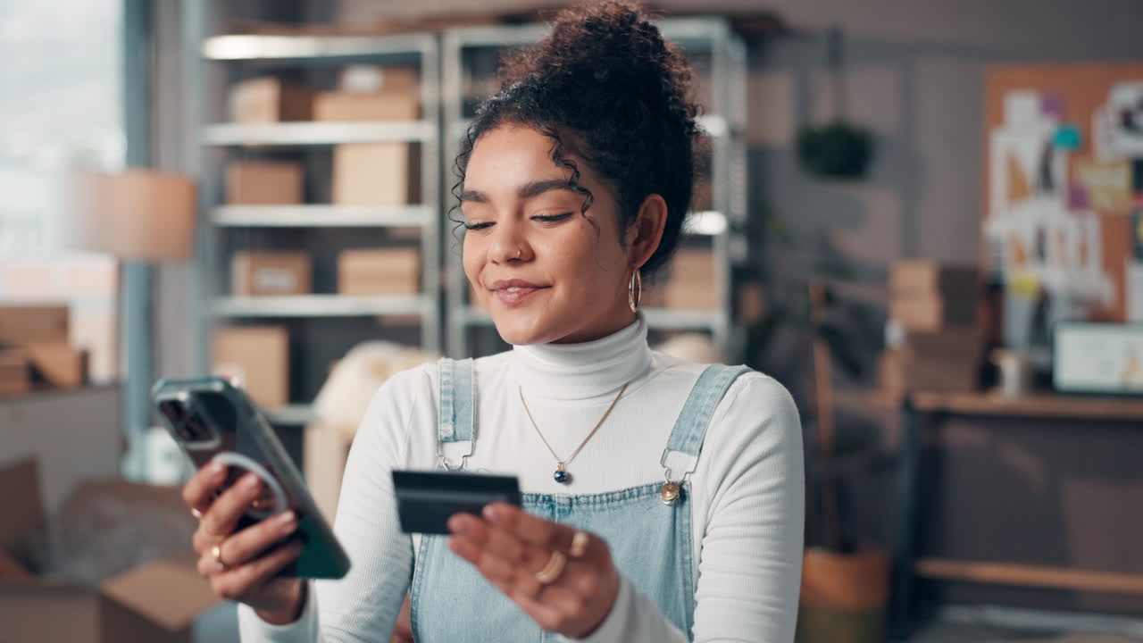 Woman using credit card and smartphone for online shopping