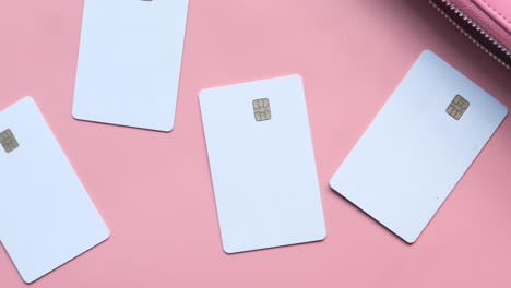 blank credit cards on a pink background