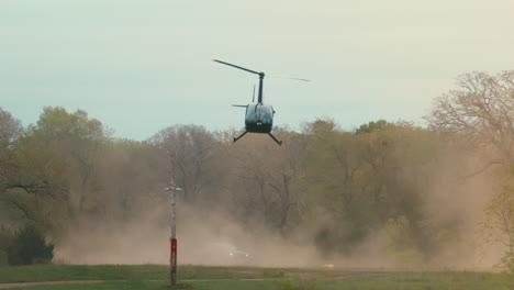 Helicopter-flying-in-super-slow-motion-over-dusty-race-car-track,-4k-800fps-aerial-helicopter-footage