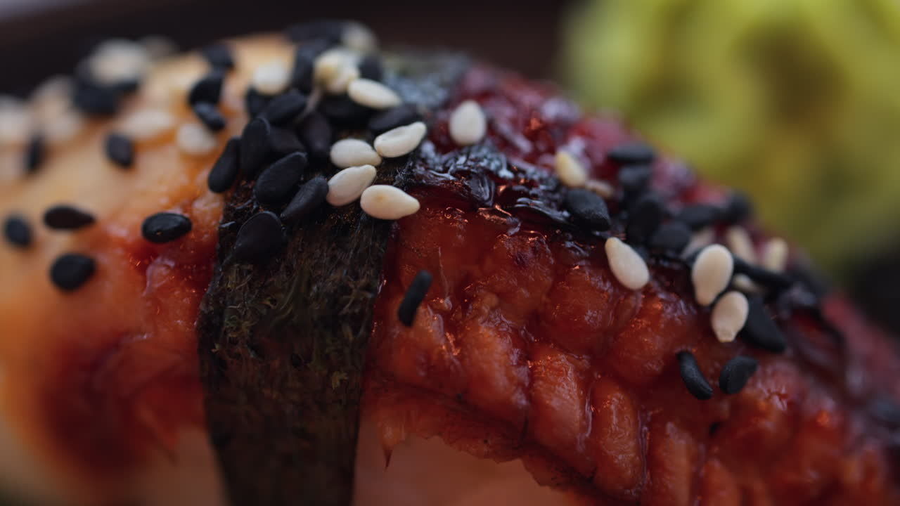 Close up of multiple nigiri on a black tray at a restaurant