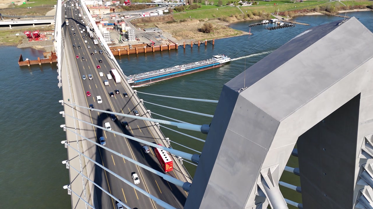 Drone angle reveals road activity and river shoreline below