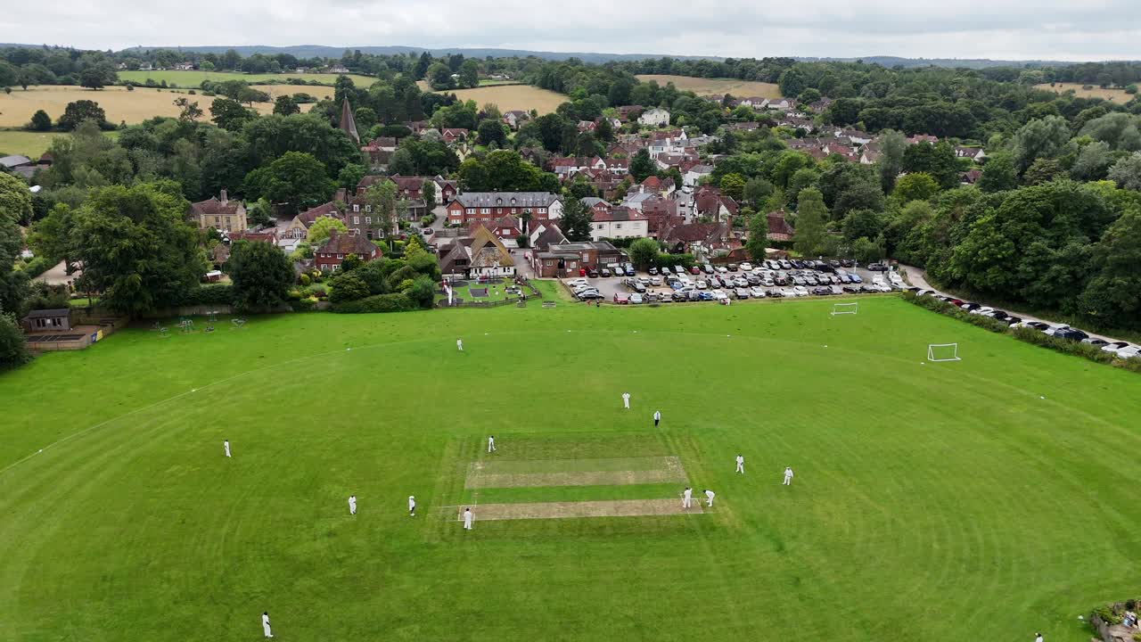 Cricket match Shere Surrey UK quaint English Village ascending drone,aerial