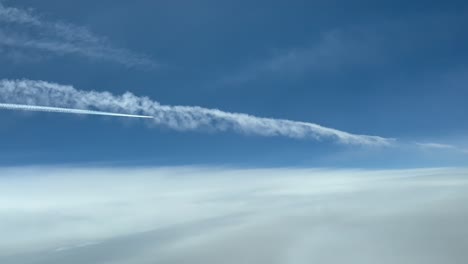 exclusive aerial shot from a plane cockpit of another preceding jet flying over a previous weak on the left side