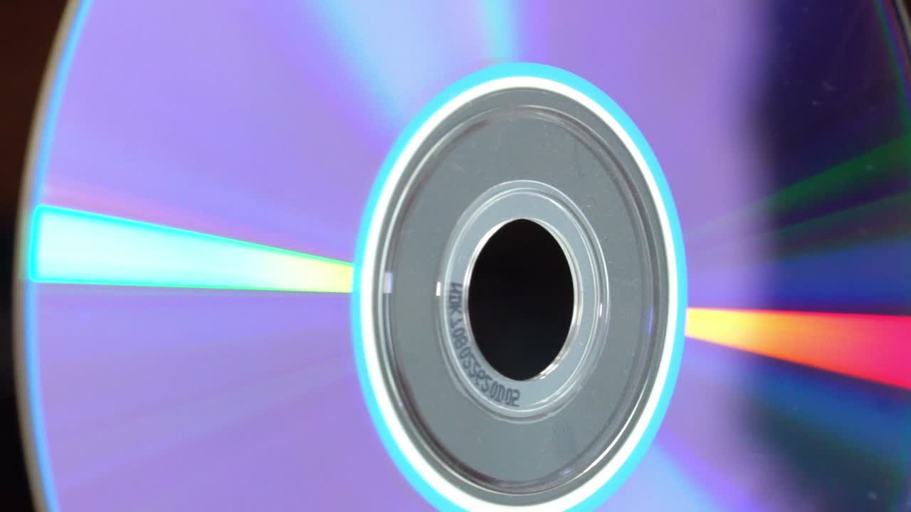 DVD CD with purple reflection in macro close-up and black background