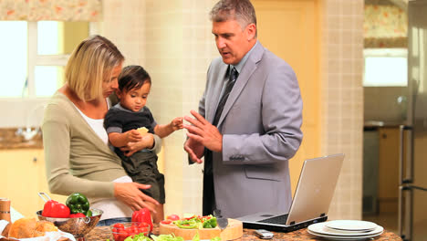 young couple with baby in kitchen