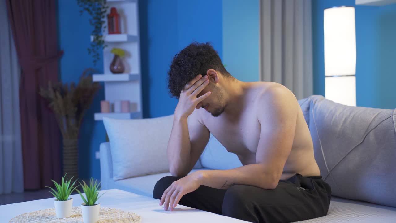 밤에 집에서 슬프고 불행한 젊은이.