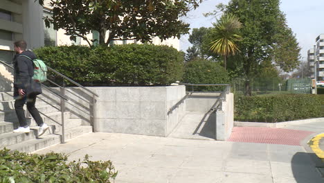 man walking up stairs in front of a building