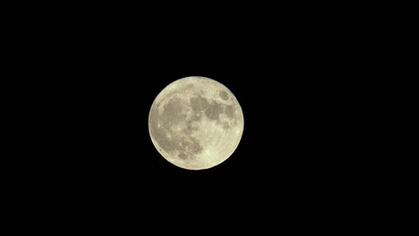 the full moon rises and crosses the frame in this lunar time lapse