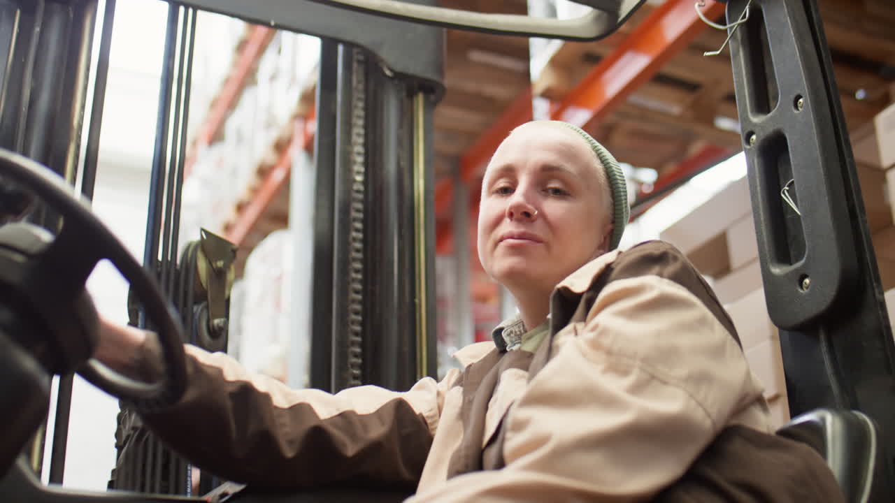 Woman Operating a Forklift in a Warehouse