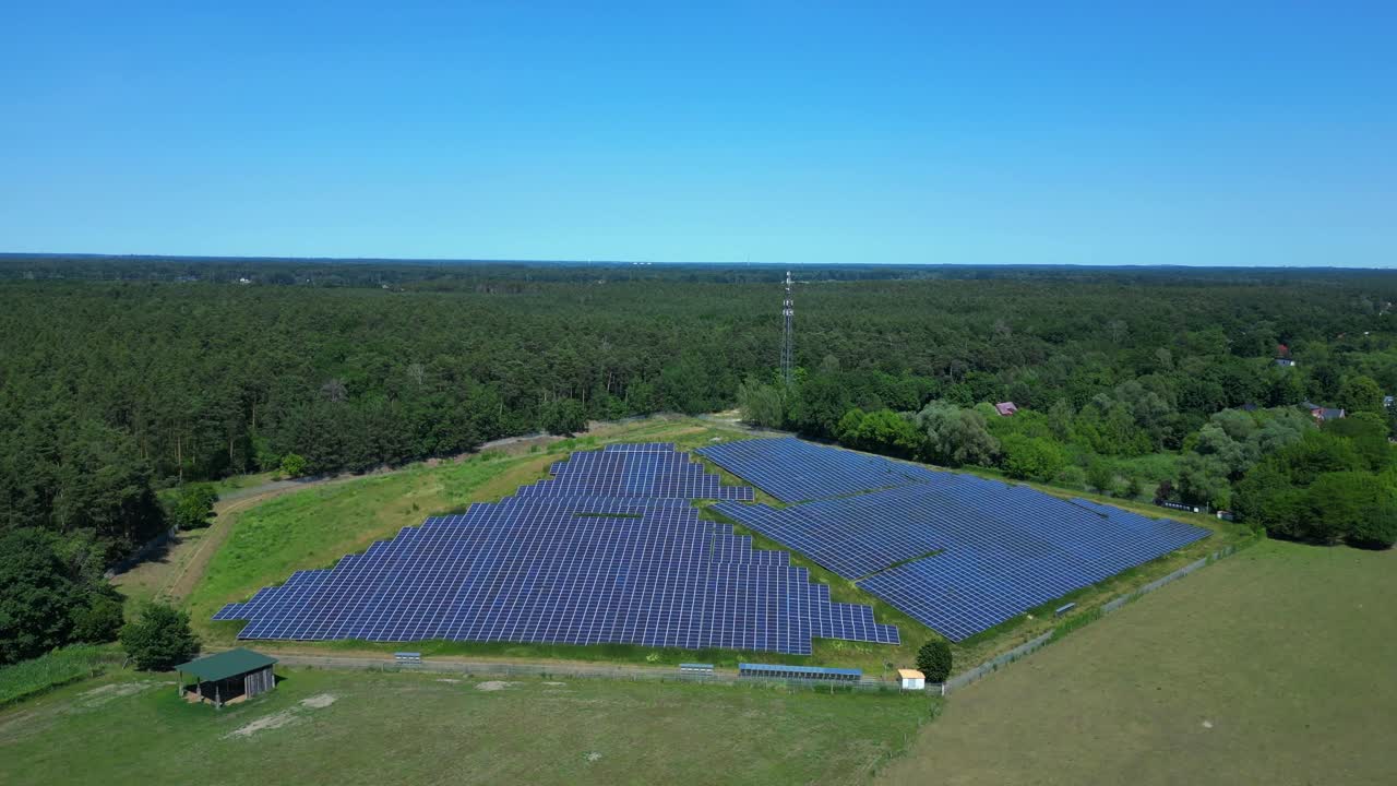Photovoltaic panels installed on a former landfill, transforming a waste site into a source of renewable energy, a sustainable solution for the future. Nice aerial view flight descending drone