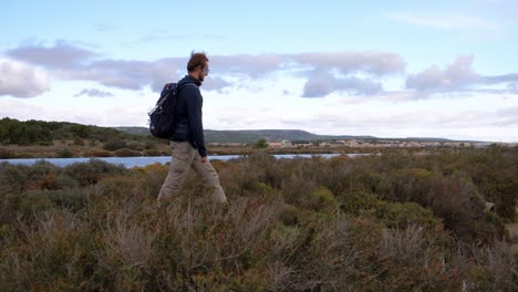 slow motion tracking shot of a man exploring the wilderness at the sete salt flats