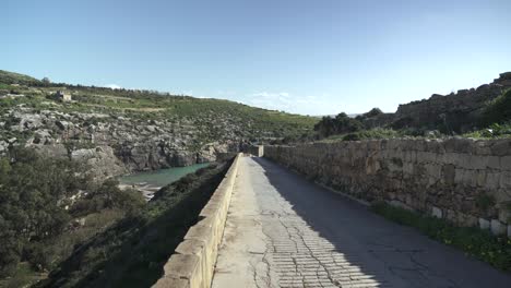 road leading to magrr ix-xini bay beach into mountains near canyon in gozo island