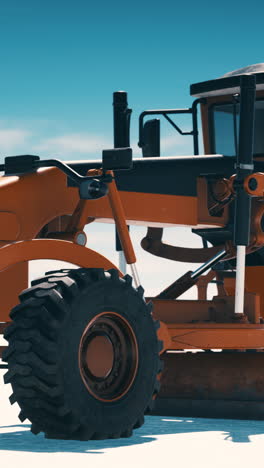 orange grader on a construction site