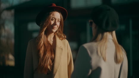 women talking at train station