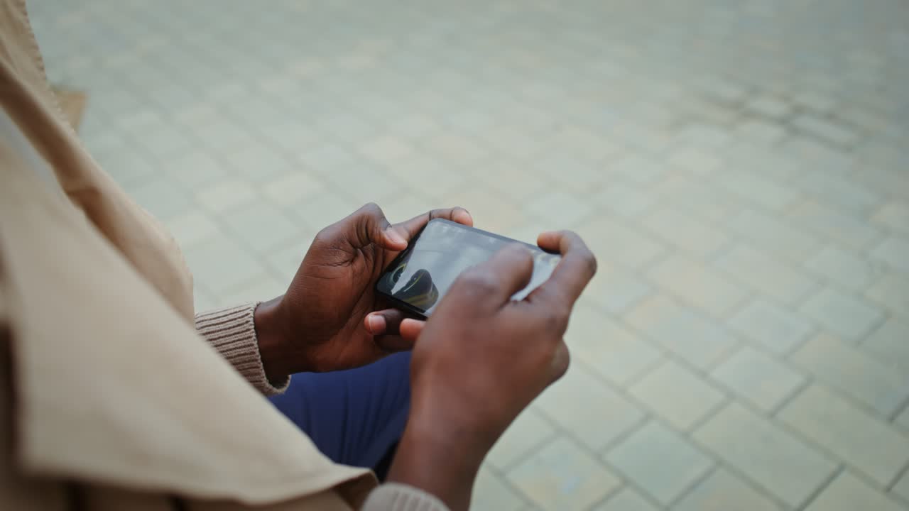 Person playing a mobile game on a smartphone