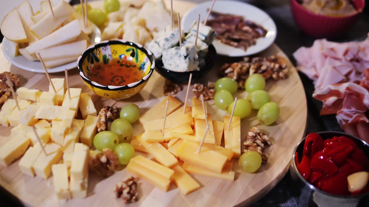 Italian or Spanish restaurant with traditional tapas food, Spanish cuisine, delicious tapas and cheese plate, bruschetta with cheese, olives dry tomatoes and tasty sandwich bar appetizer, buffet