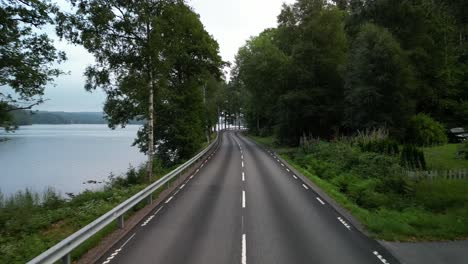 Lakeside-forested-road-in-summer