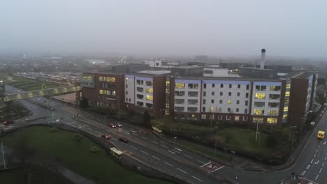 aerial view british nhs hospital on misty wet damp morning mid orbit right