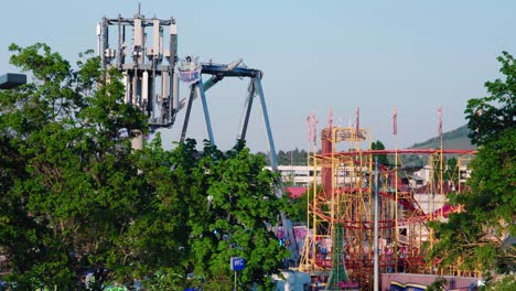 5g mobile network tower with carnival rides in the background