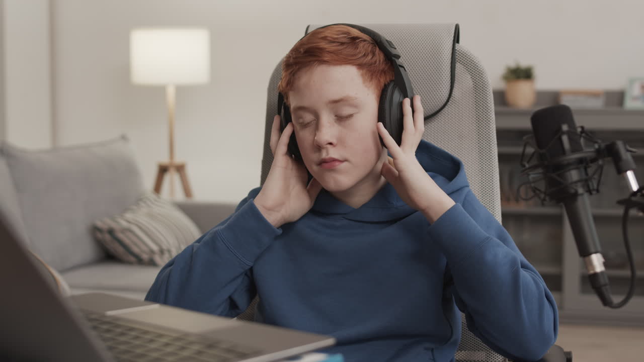 Teenage boy listening to music with headphones