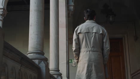 student walking in outdoor hallway at university