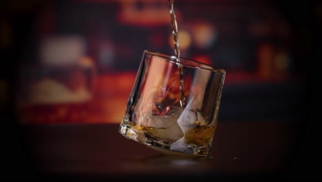 whiskey pouring into a glass with ice