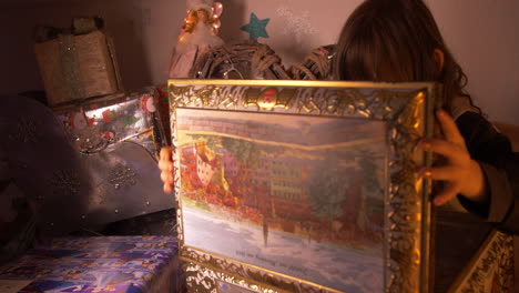 child opening beautiful decorated box case with christmas gifts