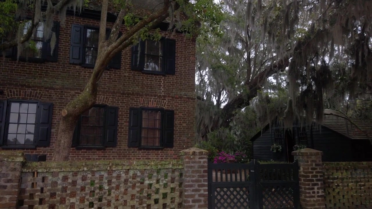 Gimbal panning shot of falling leaves in front of the Middle Place House at the historic plantation in Charleston, South Carolina. 4K at 60 FPS Slow Motion