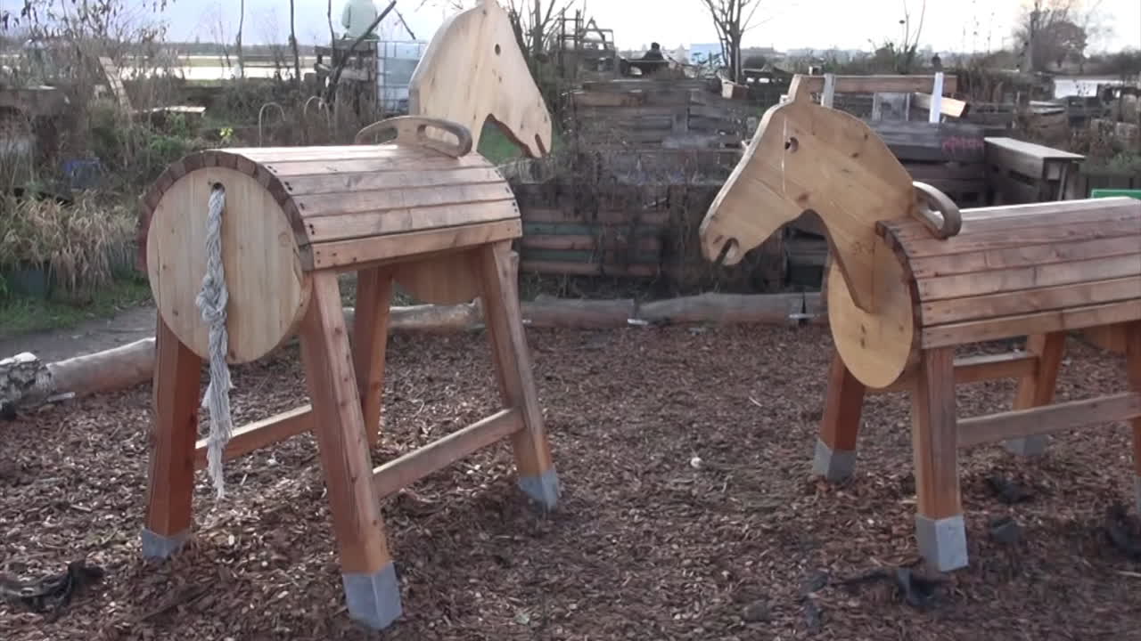 2 wooden horses in a playground in a garden in Tempelhof Aiport Berlin Neukoelln Germany 30 fps HD 5 secs