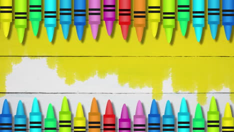 animation of colored crayons against yellow painted wooden background with copy space