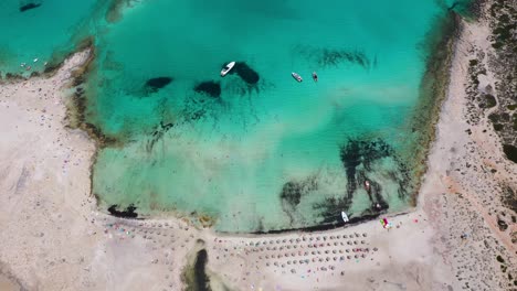 aerial drone top down of balos beach and lagoon with turquoise water, mountains and cliffs in crete, greece