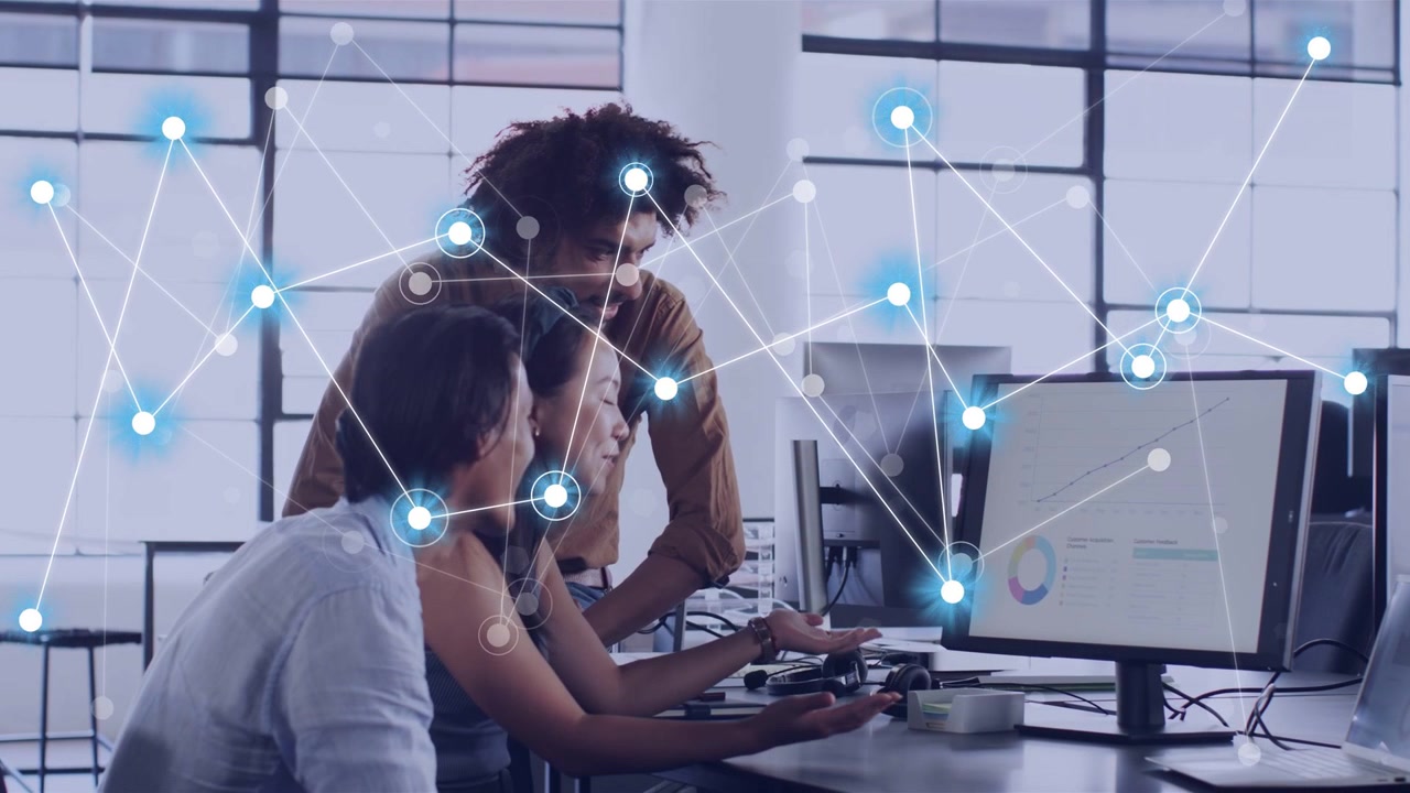 IT team leaning over screen center gesturing sparking network growing over pie or trend line analyzi