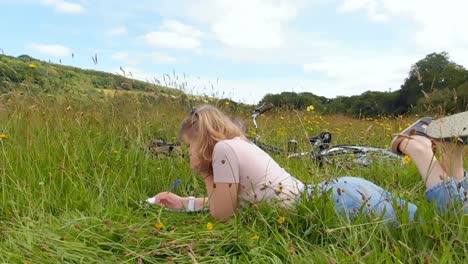 woman writing on notepad in grass field 4k