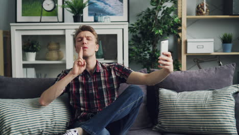 man taking a selfie on a couch