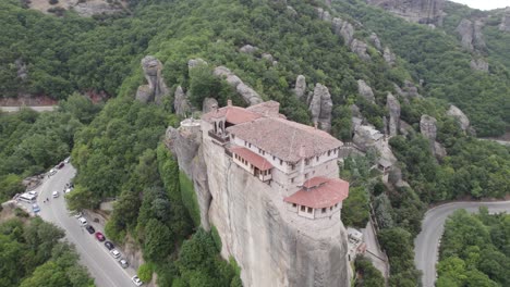 aerial view of monastery of rousanou on top of the rock, building on edge of a cliff, orbiting