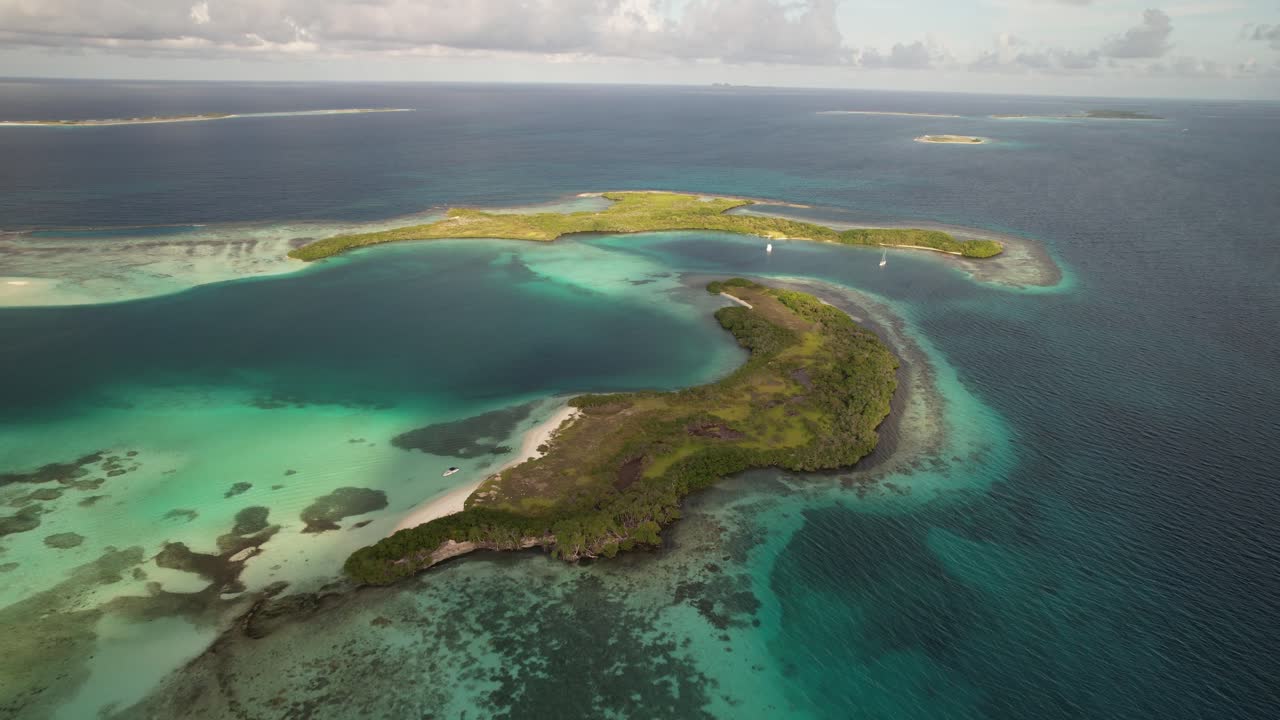 Tropical island with lush greenery and turquoise waters, peaceful mood, aerial view