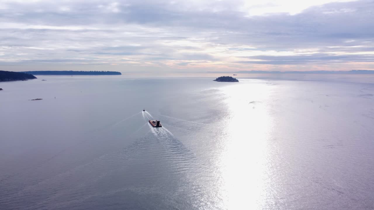 AERIAL Shot of a Tugboat pulling a Barge in Vancouver, Canada