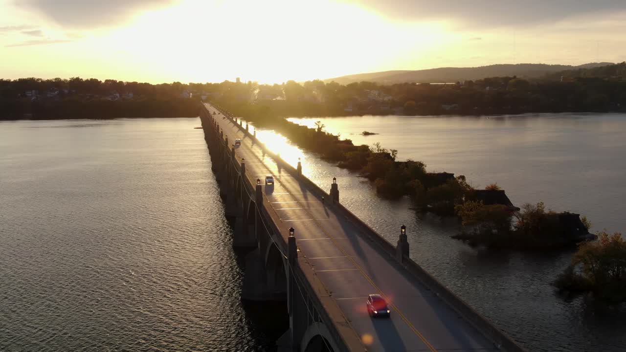 tráfico conduciendo en un largo puente histórico sobre el río susquehanna entre el condado de lancaster y el condado de york pa usa al atardecer, amanecer