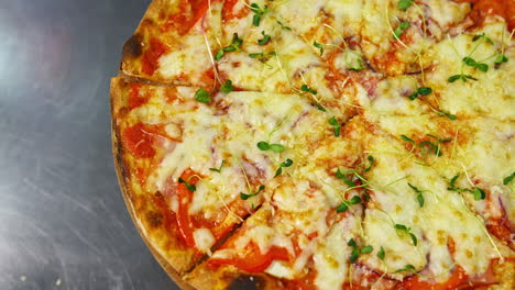 delicious pizza. ready pizza with melted cheese rotating on a table in pizzeria. well baked pizza in a restaurant. close-up.