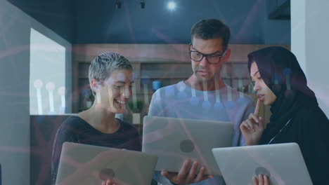 animation of scientific data over diverse female and male coworkers using laptop