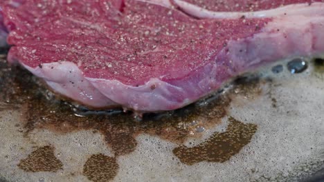 closeup of entrecote beef frying in butter