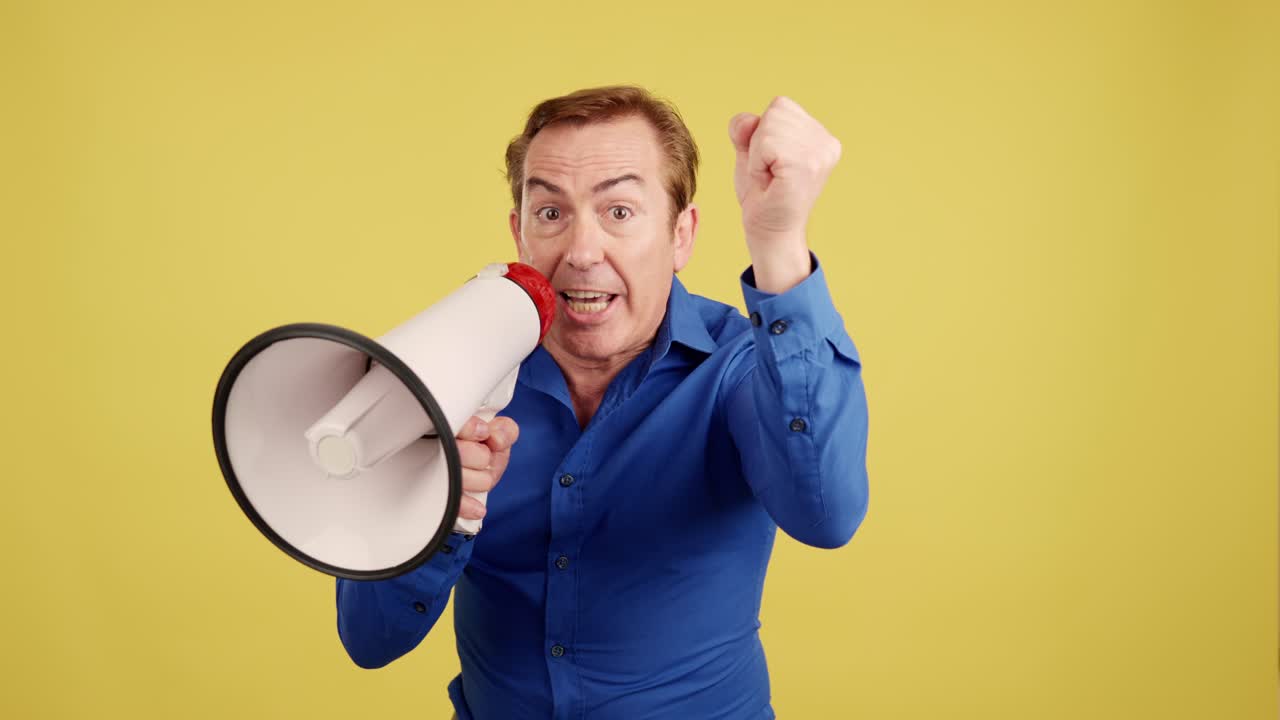 A man holding a megaphone and shouting loudly