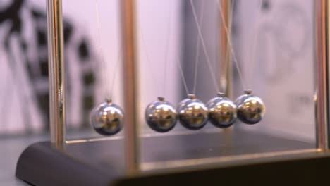 pendulum with swinging metal spheres in 4k slow motion 60fps