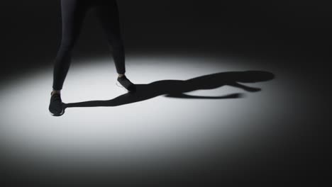 close up studio shot of woman shadow boxing in gym