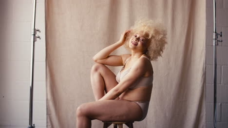 studio portrait shot of confident natural albino woman in underwear promoting body positivity